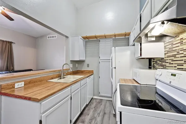 a kitchen with a sink appliances and cabinets