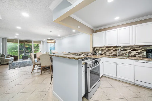 a kitchen with granite countertop white cabinets and white appliances
