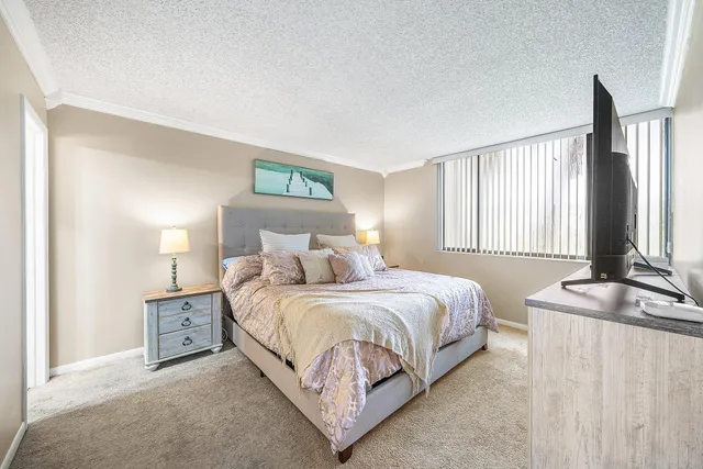 a bedroom with a bed and a night stand