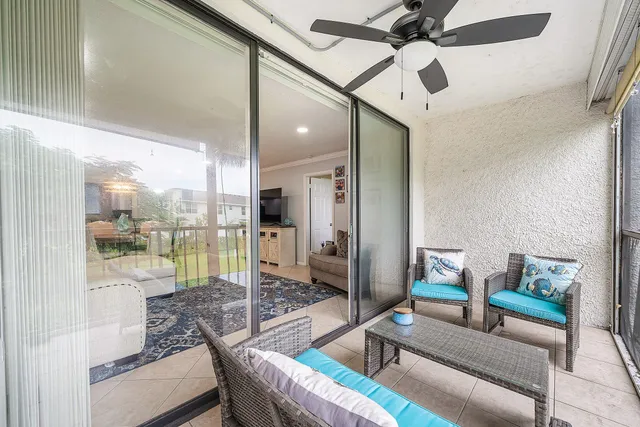 a living room with furniture and a floor to ceiling window