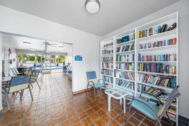 a living room with furniture and a book shelf
