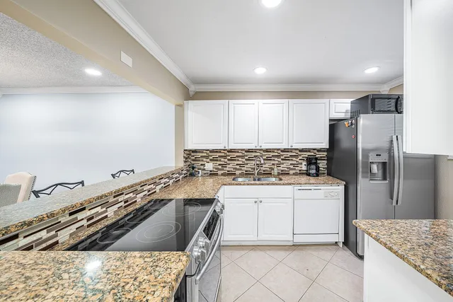 a kitchen with a sink stove and refrigerator