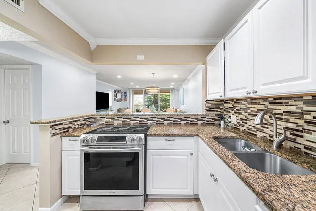 a kitchen with a stove top oven and cabinets