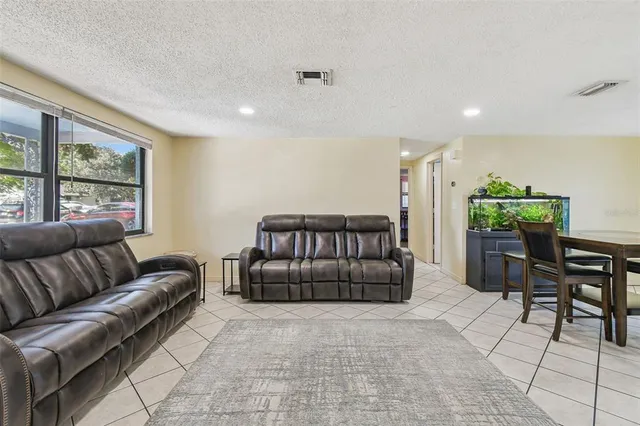 a view of a dining room with furniture and a potted plant