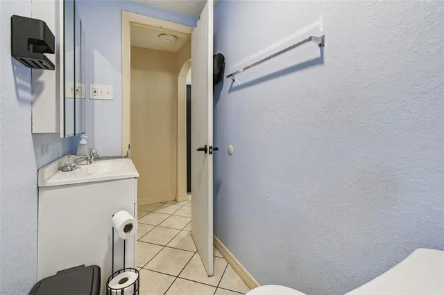 a bedroom with a bed a table and a window