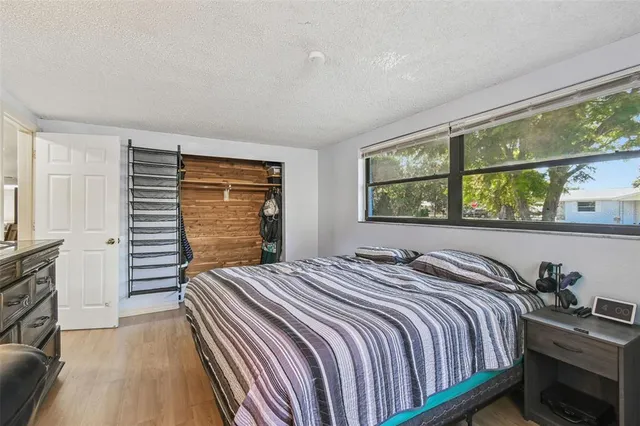 a front view of a house with a yard and potted plants
