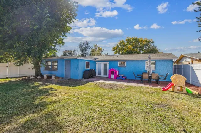 an aerial view of residential houses with outdoor space and swimming pool