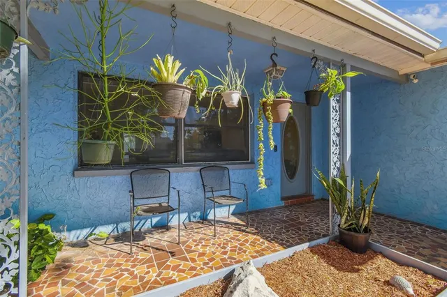 a living room with furniture and a dining table with projector