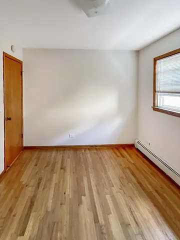 a view of an empty room and wooden floor