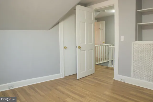 a view of a house with a small yard and wooden floor and fence