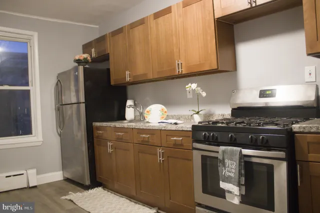a kitchen with granite countertop cabinets stainless steel appliances and a sink