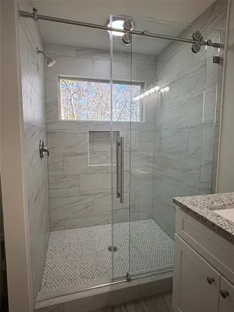a bathroom with a shower and a sink