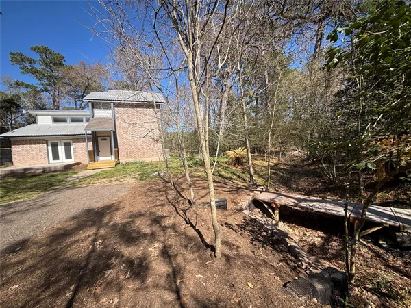 a backyard of a house with table and chairs