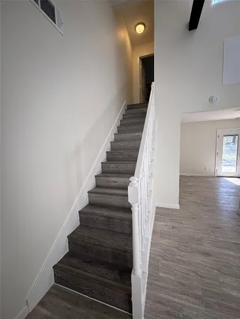 a view of entryway and hall with wooden floor