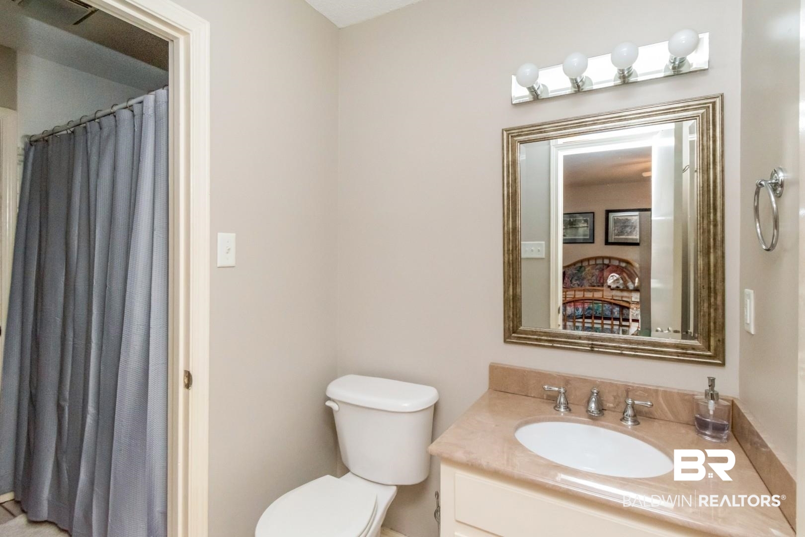 118 Du Rhu Drive, Unit H Mobile, AL 36608 - Photo 13 of 19 Bathroom vanity featuring a single basin sink, light-toned countertop, and framed mirror