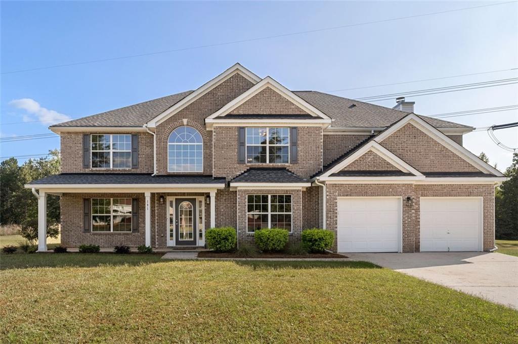 a front view of a house with a yard