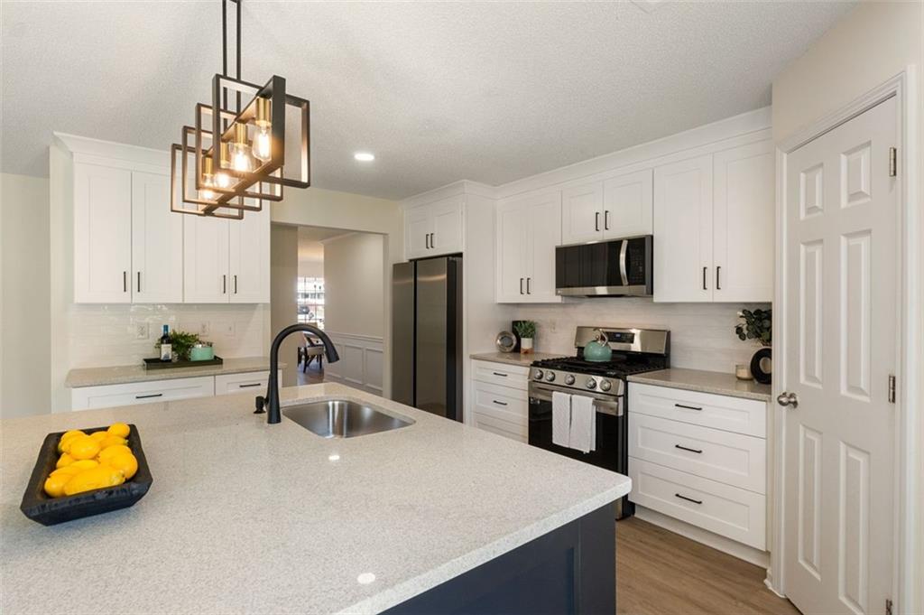 191 Kyndal Drive Hampton, GA 30228 - Photo 14 of 49 a kitchen with white cabinets and stainless steel appliances