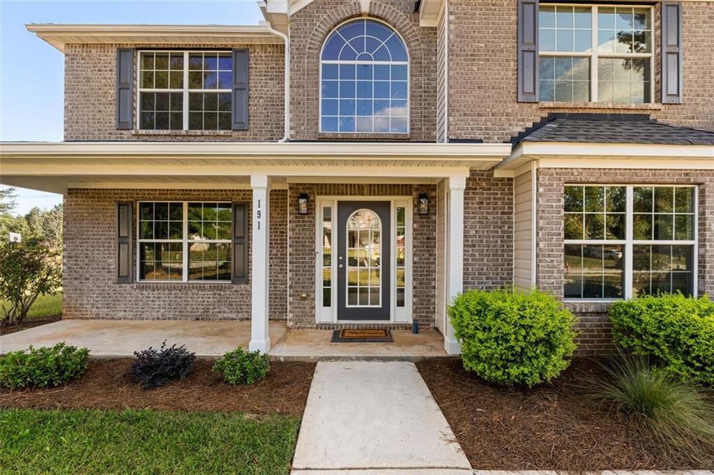 191 Kyndal Drive Hampton, GA 30228 - Photo 2 of 49 front view of a brick house with a small yard