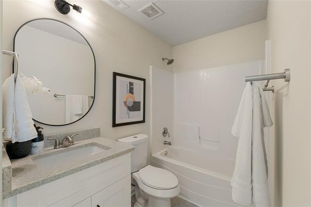 191 Kyndal Drive Hampton, GA 30228 - Photo 22 of 49 a bathroom with a granite countertop sink toilet and shower