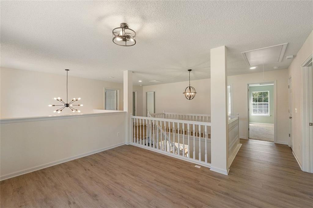 191 Kyndal Drive Hampton, GA 30228 - Photo 27 of 49 a view of a hallway with wooden floor