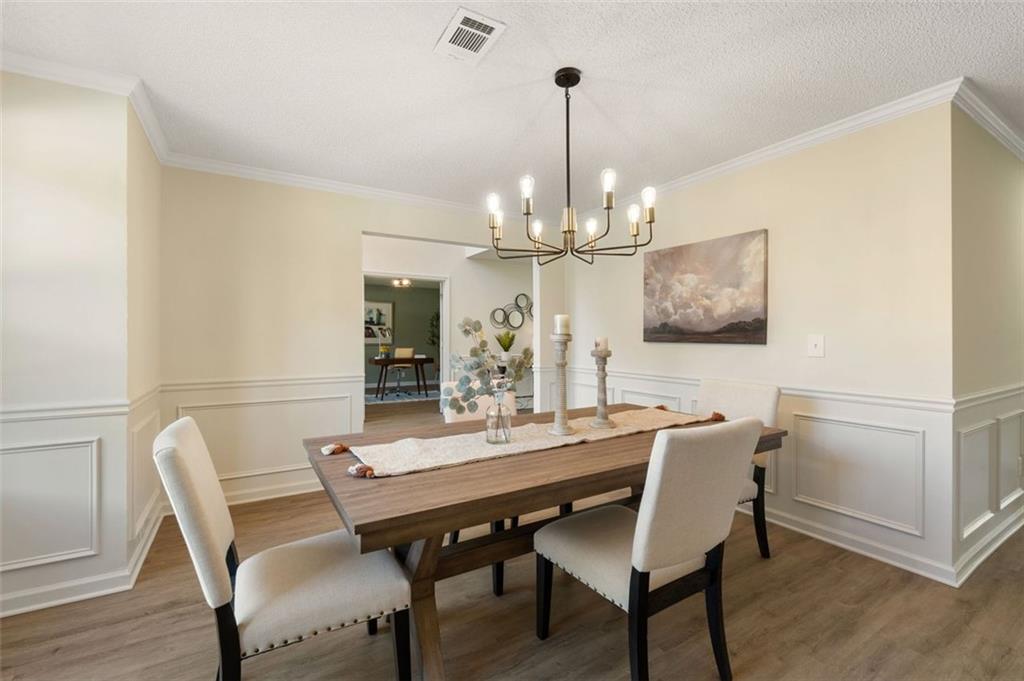 191 Kyndal Drive Hampton, GA 30228 - Photo 8 of 49 a view of a dining room with furniture a chandelier and wooden floor