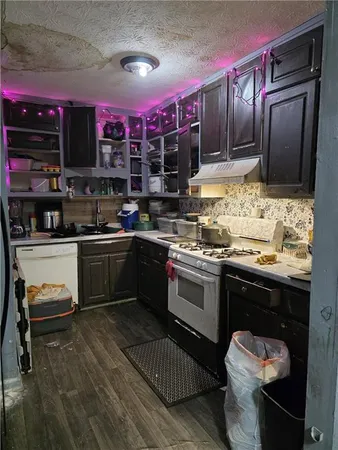 a kitchen with a sink stove and cabinets