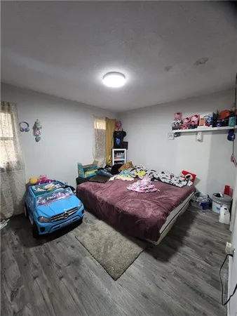 a bedroom with bed and a chandelier