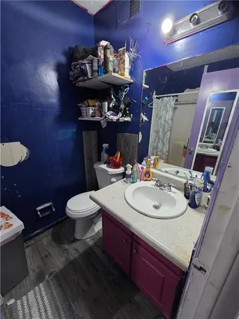 a bathroom with a sink vanity mirror and toilet