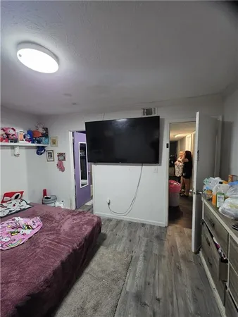 a bedroom with a bed and a view of kitchen