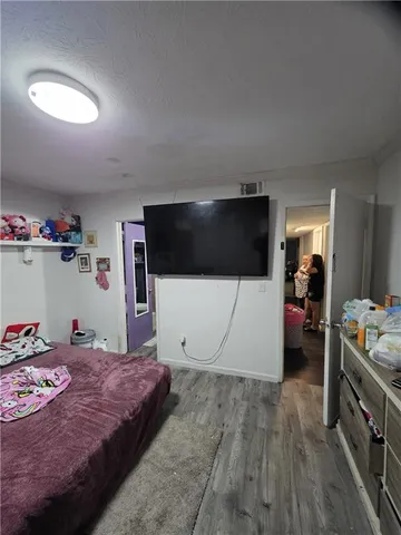 a bedroom with a bed and a view of kitchen