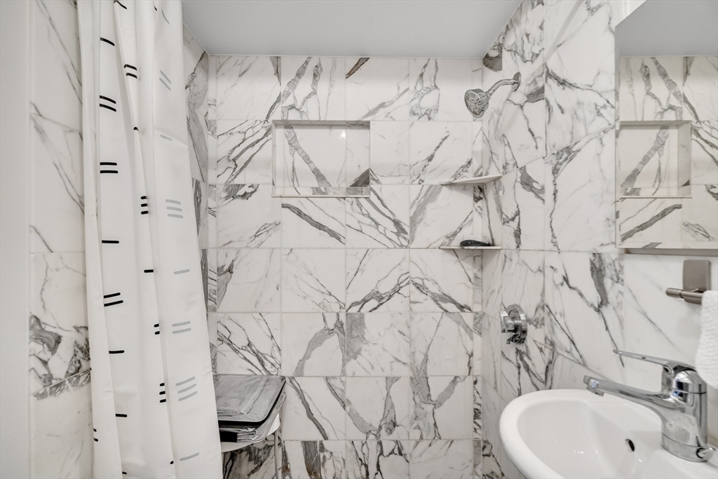 290 Commonwealth Avenue, Unit 8 Boston, MA 02115 - Photo 20 of 32 a bathroom with a sink and mirror with toilet