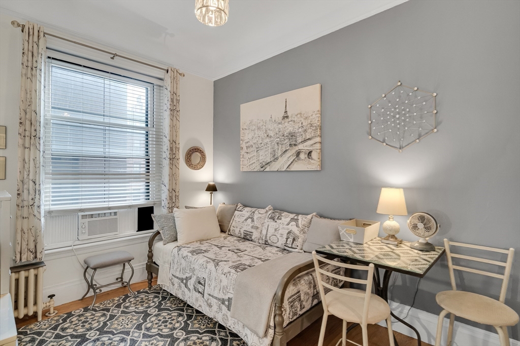 290 Commonwealth Avenue, Unit 8 Boston, MA 02115 - Photo 5 of 32 a bedroom with a bed and a table in it