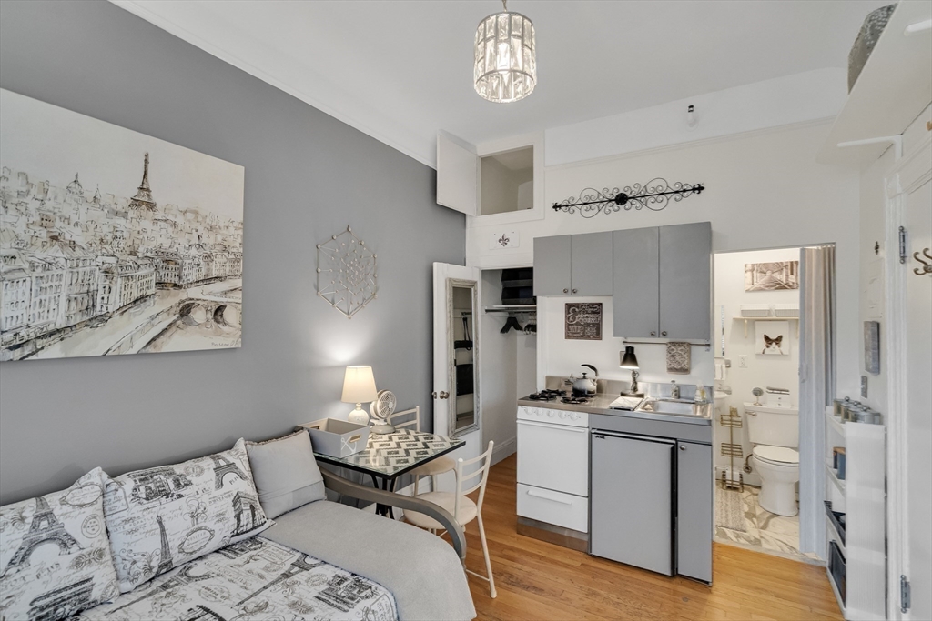 290 Commonwealth Avenue, Unit 8 Boston, MA 02115 - Photo 6 of 32 a bedroom with furniture and a fireplace