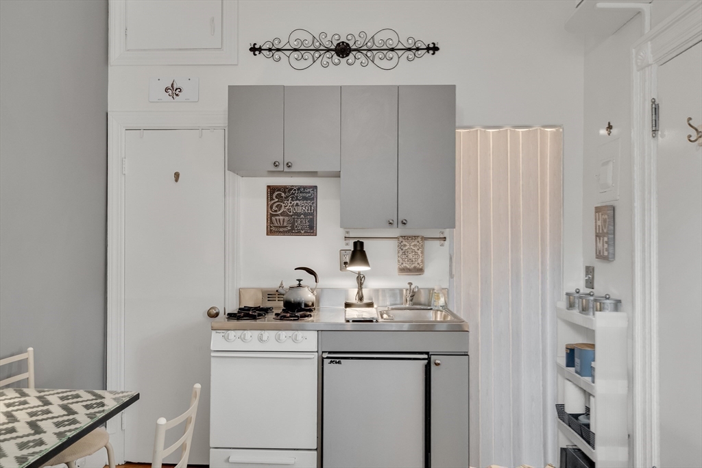 290 Commonwealth Avenue, Unit 8 Boston, MA 02115 - Photo 10 of 32 a kitchen with cabinets appliances and a sink