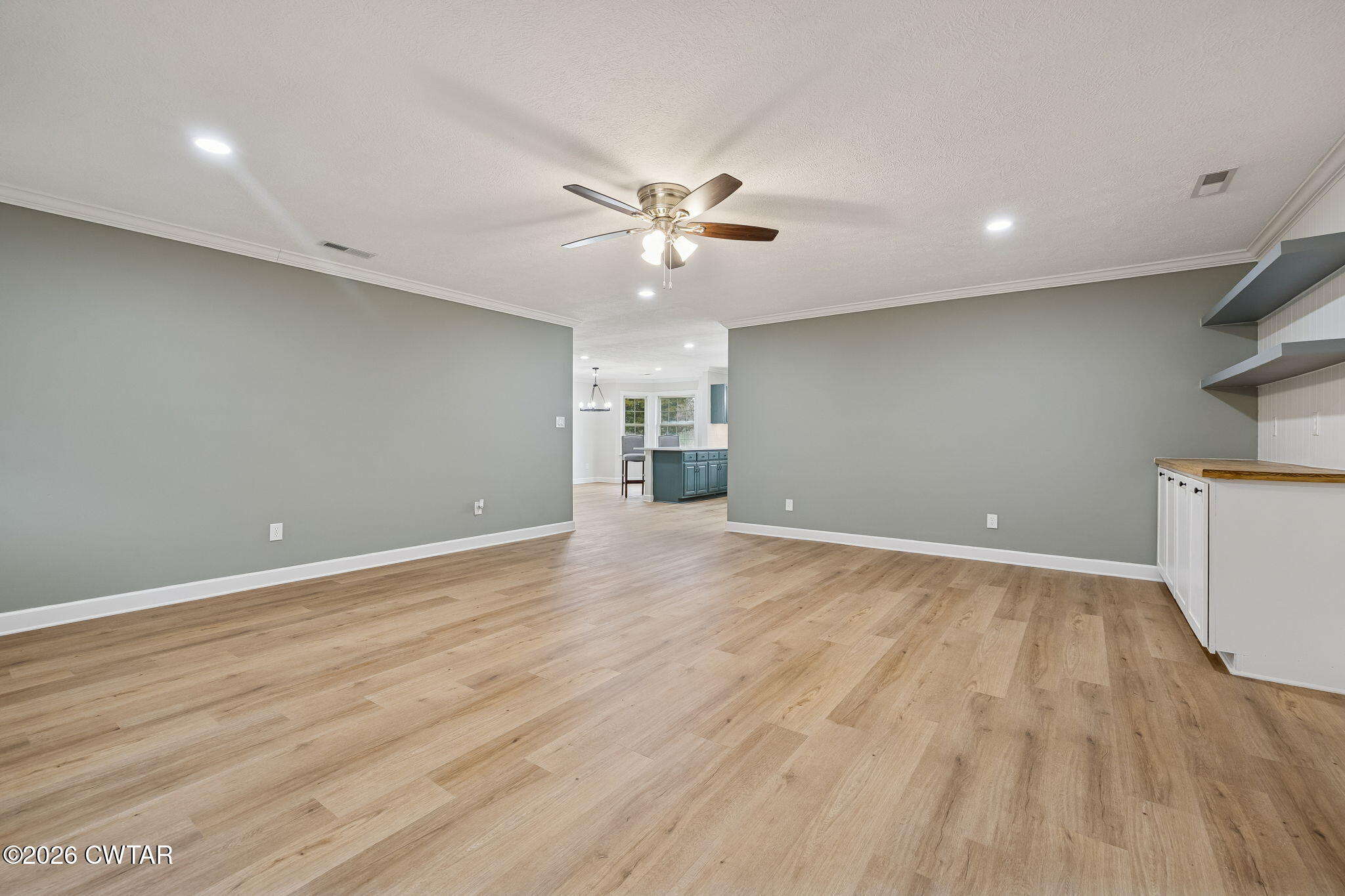 123 Walnut Hill Road Bells, TN 38006 - Photo 9 of 61 an empty room with wooden floor and a ceiling fan