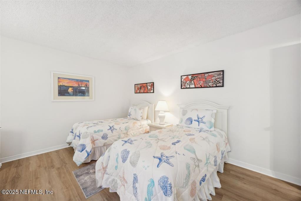 2021 Beachwood Road Fernandina Beach, FL 32034 - Photo 16 of 32 a bedroom with a bed and a wall painting