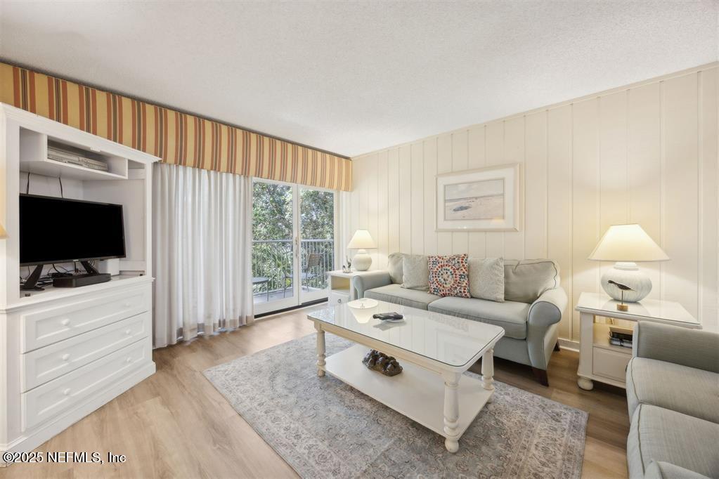 2021 Beachwood Road Fernandina Beach, FL 32034 - Photo 3 of 32 a living room with furniture a flat screen tv and a window