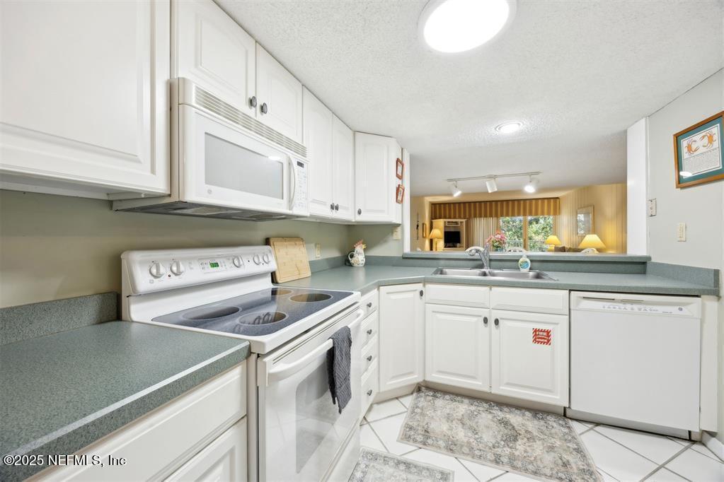 2021 Beachwood Road Fernandina Beach, FL 32034 - Photo 4 of 32 a kitchen with a sink cabinets and appliances