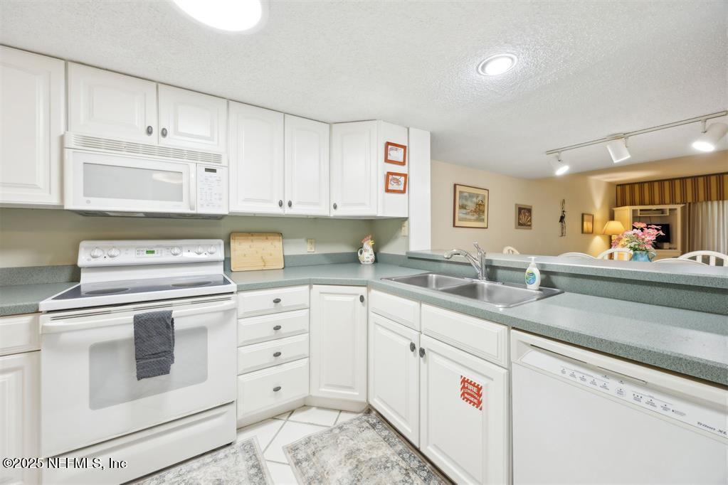 2021 Beachwood Road Fernandina Beach, FL 32034 - Photo 9 of 32 a kitchen with cabinets appliances a sink and a counter top space