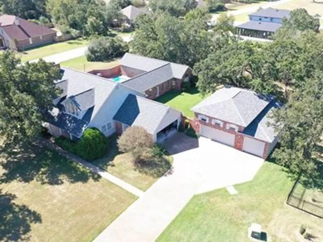 an aerial view of a house with a yard