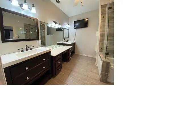 a bathroom with a sink double vanity and a mirror