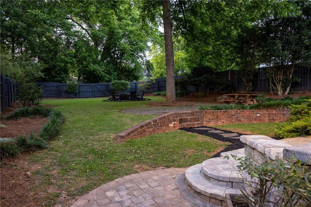 266 Atlanta Avenue Southeast Atlanta, GA 30315 - Photo 67 of 70 a view of a backyard with table and chairs potted plants and large tree