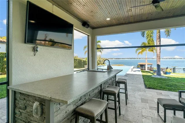 a view of swimming pool with outdoor seating and plants