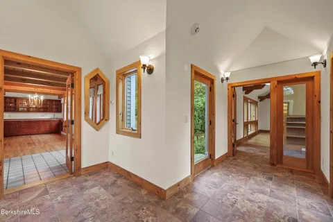 a view of an entryway with wooden floor and door