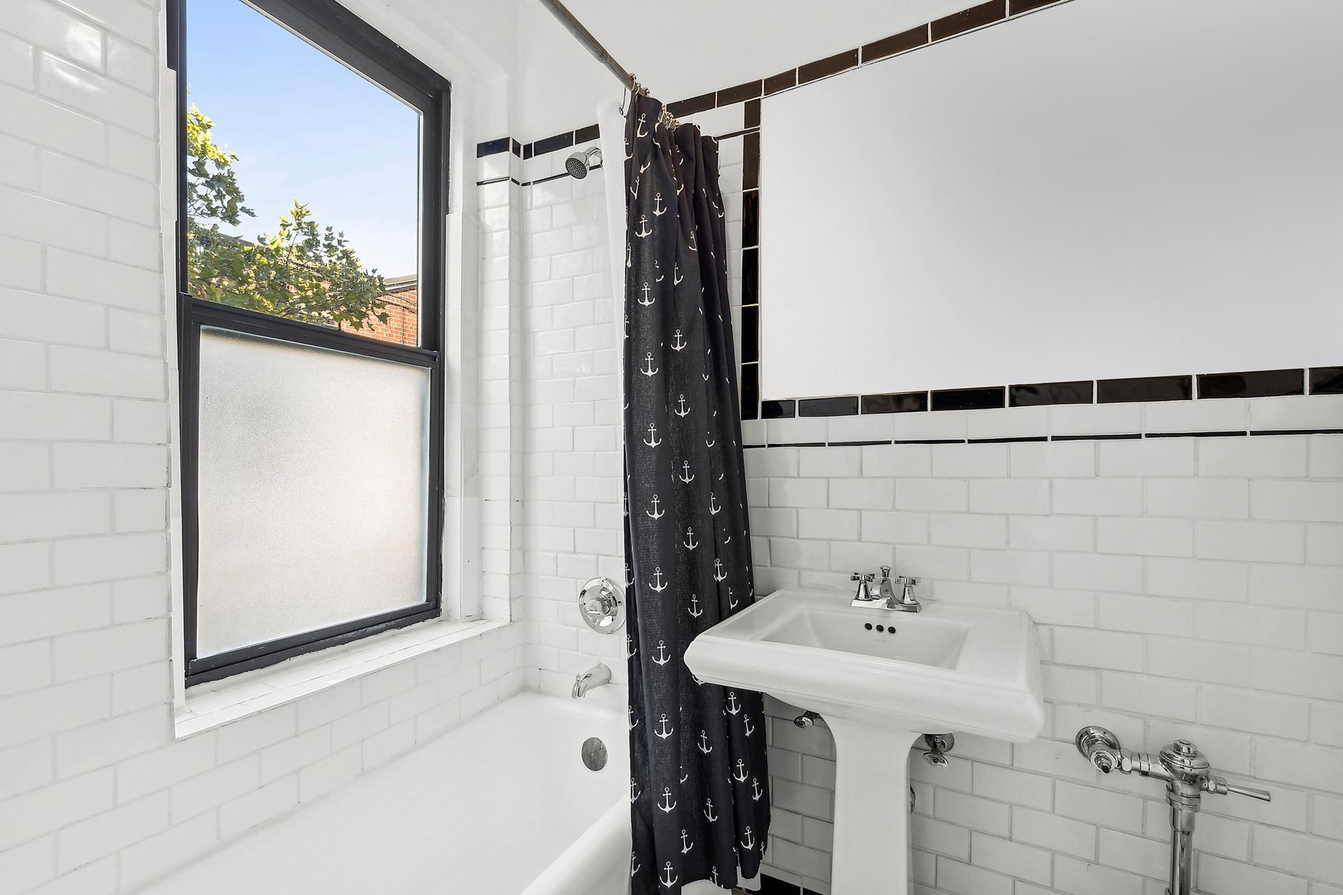 1-03 Minetta Street, Unit 5B Manhattan, NY 10012 - Photo 5 of 12 a bathroom with a sink and shower