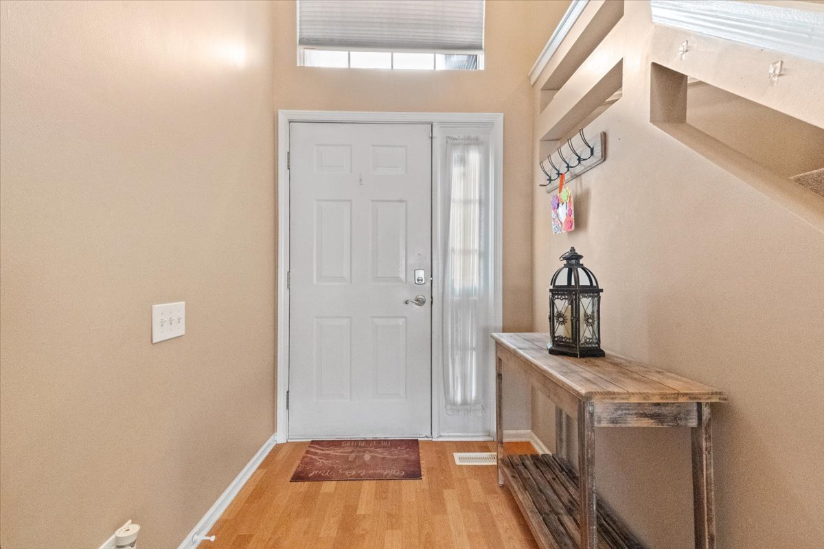 423 Spaulding Road Bartlett, IL 60103 - Photo 3 of 28 a view of a room with rack on the wall and a white door