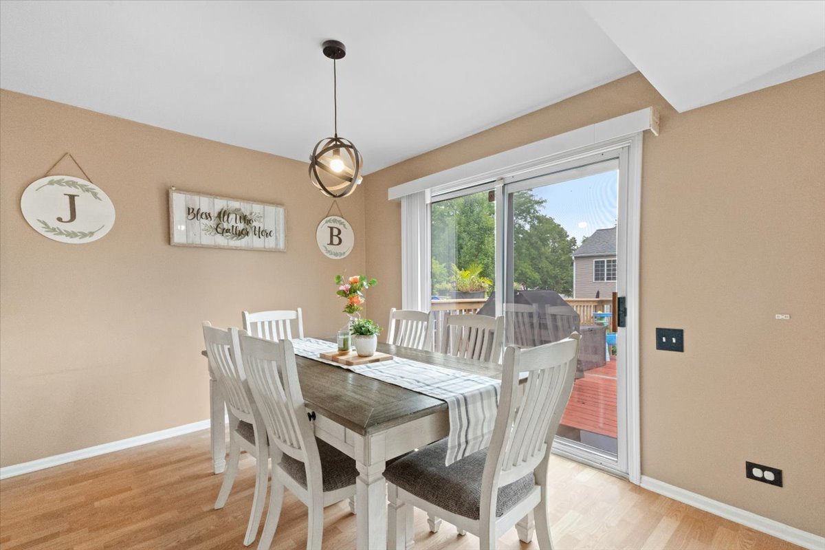 423 Spaulding Road Bartlett, IL 60103 - Photo 7 of 28 a view of a dining room with furniture window and wooden floor