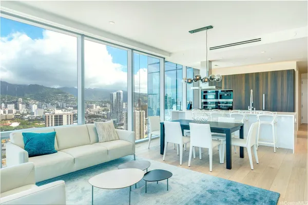 a living room with furniture a large window and a chandelier