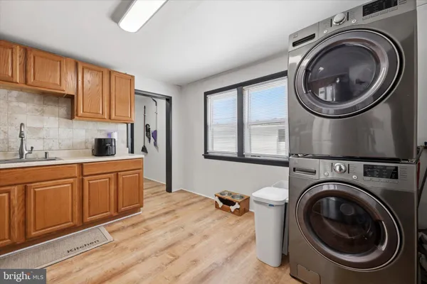 a kitchen with a washer and dryer in it