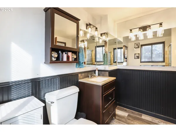 a bathroom with a sink a toilet and a mirror